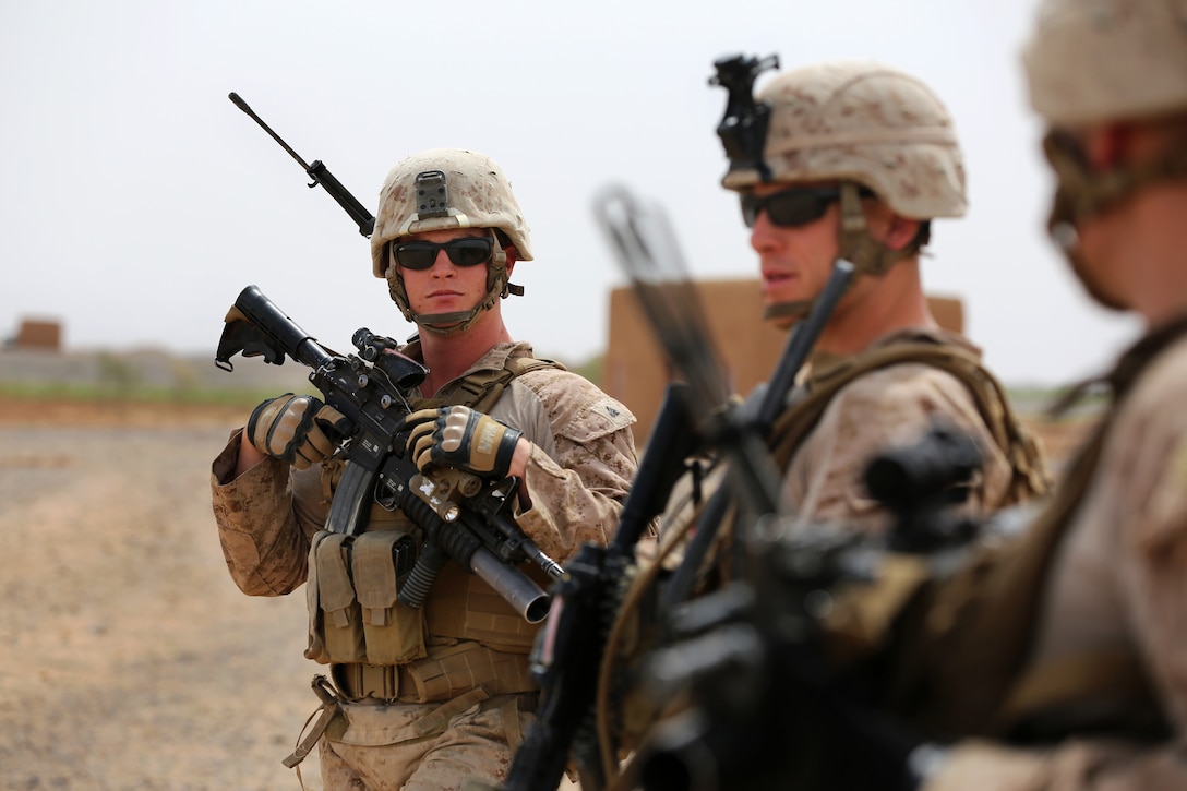 U.S. Marine Corps 1st Lt. Michaele Haynes, center, and U.S. Marine ...