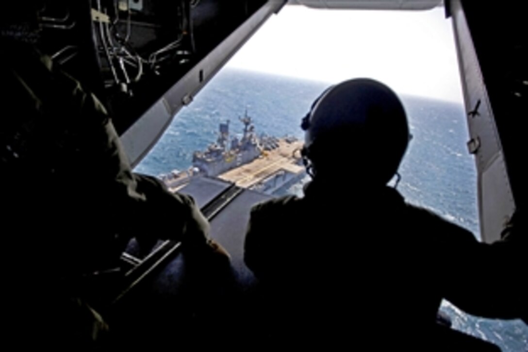 U.S. Marine Corps Corporal Navarrete Angle and U.S. Marine Corps Lance Cpl. Justin Ranum take off from the USS Bonhomme Richard in an MV-22 Osprey, April 20, 2014, to assist South Korea's search operations for the Sewol. Angle and Ranum are crew chiefs assigned to Marine Medium Tiltrotor Squadron 265, 31st Marine Expeditionary Unit.