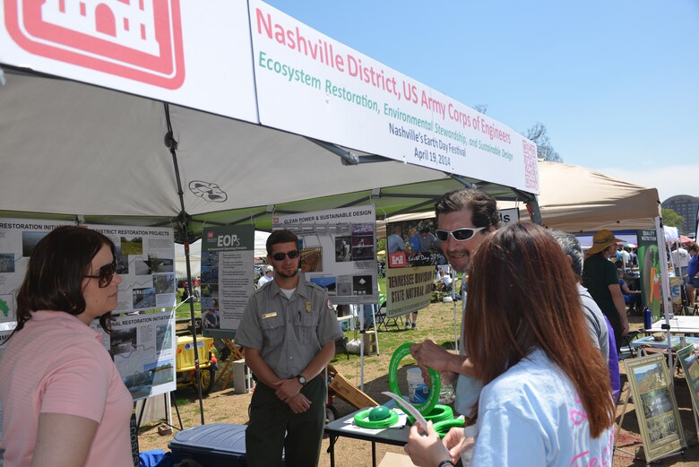 Mary Lewis, biologist, Customer Outreach and Silver Jackets coordinator for the U.S. Army Corps of Engineers, Nashville District, (Left) and Ben MacIntyre, a park ranger from J. Percy Priest Lake Resource Center (right) talk with a couple as they stopped at the Nashville District booth during the 13th annual Nashville Earth Day Festival at Centennial Park April 19. The event featured exhibits and activities aimed at educating everyone about protecting our environment. The environmental friendly festival drew environmentalists of all ages to hundreds of family-friendly eco booths, hosted by government agencies, environmental organizations, and community groups who provided t-shirts, cups, pencils and goodies for all ages. 