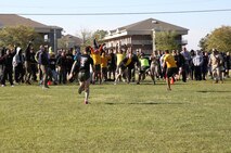Marines and sailors with Combat Logistics Regiment 25, 2nd Marine Logistics Group cheer as service members stagger toward the finish line during the “Dizzy Izzy” at a field meet aboard Camp Lejeune, N.C., April 16, 2014. The purpose of the field meet was to give Marines and sailors with the regiment a chance to have fun together before many of them deploy or leave their units during the summer.