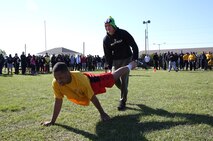 Service members with Combat Logistics Regiment 25, 2nd Marine Logistics Group participate in a buddy race during a field meet aboard Camp Lejeune, N.C., April 16, 2014. The CLR-25 command organized the field meet to build teamwork within the unit and provide an opportunity for the Marines and sailors to have fun while engaging in physical activities.