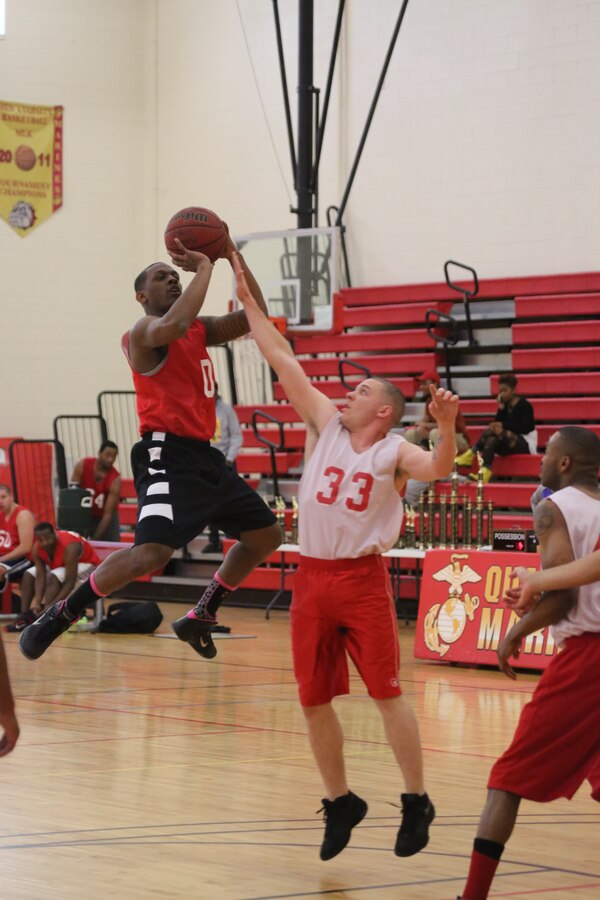 Freddie Myles, a forward for the Headquarters and Service Bn. intramural basketball team, takes a jump shot during the Quantico Intramural Basketball League championship game agains the H&S Bn. Finance Section team on April 17, 2014, at the Barber Physical Activity Center. Myles and the H&S Bn. team kept the score close the whole game but couldn't take the lead and lost, 65-56.