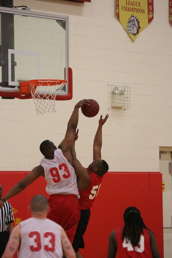 Richard Pollock, a player for the Headquarters and Service Bn. Finance intramural basketball team, blocks a shot during the Quantico Intramural Basketball League Championship Game against the H&S Bn. team at the Barber Physical Activity Center on April 17, 2014. The Finance team took the lead early in the game, never let up and won, 65-56.