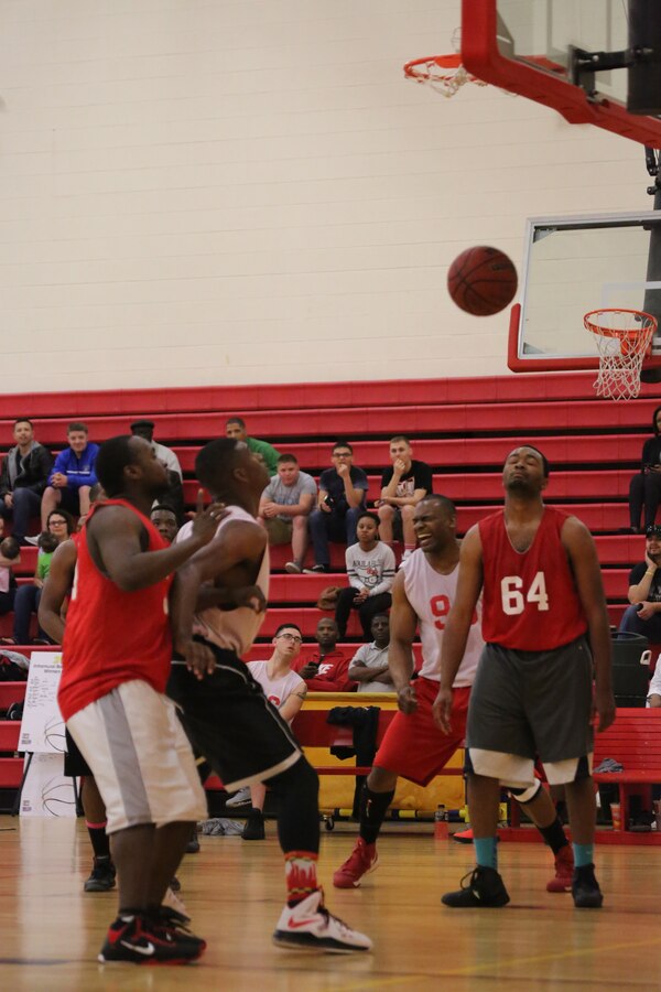 Joseph Fears, a player for the Headquarters and Service Bn. intramural basketball team, closes his eyes in acceptance while Richard Pollock, a player for the H&S Bn. Finance team, yells in victory as his teammate scores another basket to widen the lead they held over the H&S Bn. team during the Quantico Intramural Basketball Championship Game at Barber Physical Activity Center on April 17, 2014. Finance took the lead early in the game, never allowing H&S Bn. to surpass them, and won, 65-56.