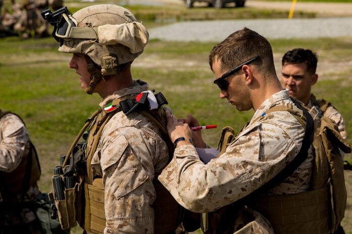 A Marine with 2nd Maintenance Battalion, 2nd Marine Logistics Group marks coordinates on a map during a super squad competition aboard Camp Lejeune, N.C., April 17, 2014. The coordinates represented different stations, where each squad was required to complete a challenge. (U.S. Marine Corps photo by Cpl. Shawn Valosin)