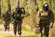 Marines with 2nd Maintenance Battalion, 2nd Marine Logistics Group hike in Mission Oriented Protective Posture gear during a super squad competition aboard Camp Lejeune, N.C., April 17, 2014. Six squads competed for a trophy and bragging rights during the grueling 12-hour struggle.  (U.S. Marine Corps photo by Cpl. Shawn Valosin)