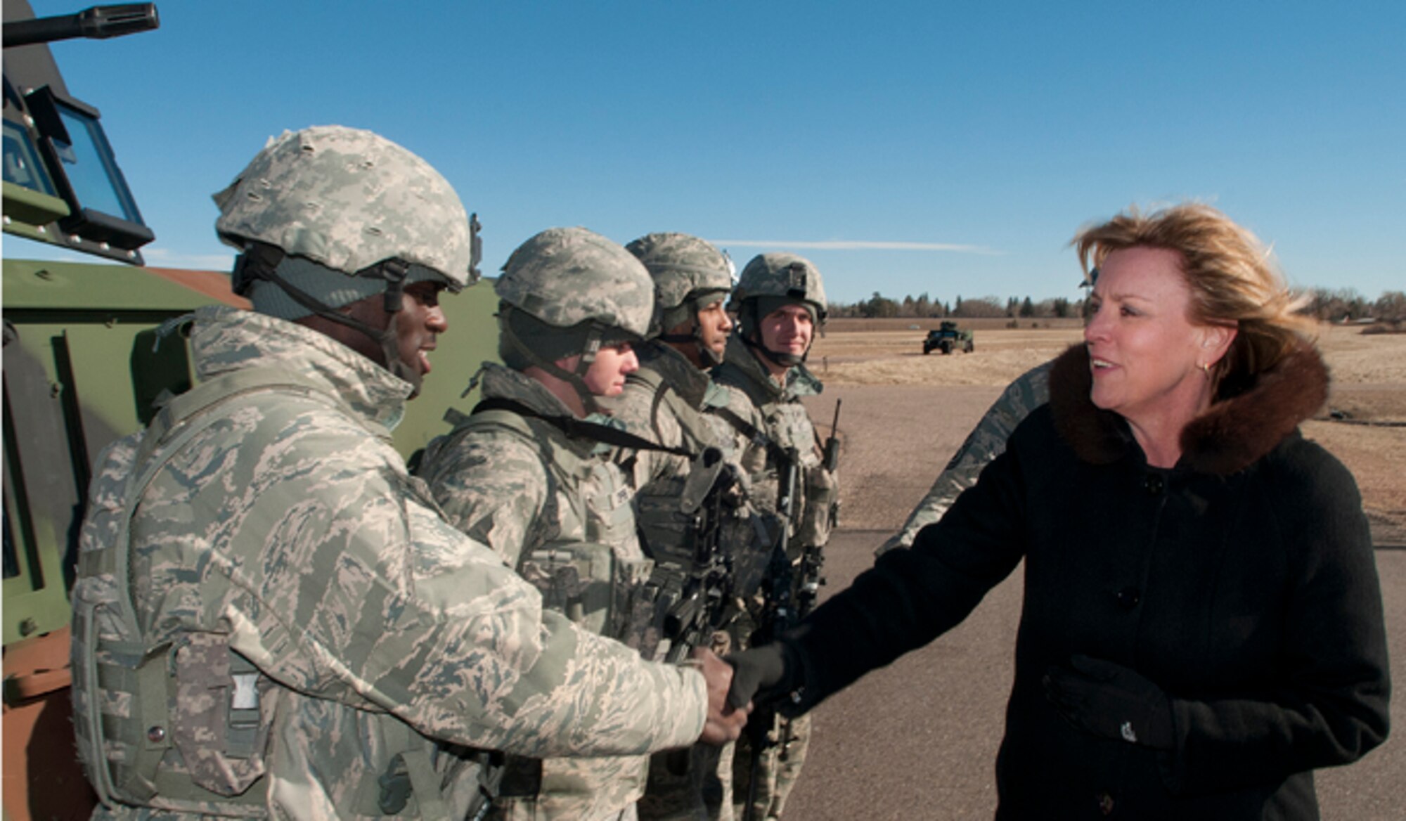 Secretary of the Air Force Deborah Lee James shakes hands with Senior Airmen Travis Lawton, , during a visit to F.E. Warren Air Force Base, Wyo., Jan. 21, 2014. James visited the 20th Air Force and 90th Missile Wing on F.E. Warren to learn about the ICBM mission. Lawton is a 790th Missile Security Forces Squadron fire team member. (U.S. Air Force photo/R.J. Oriez)