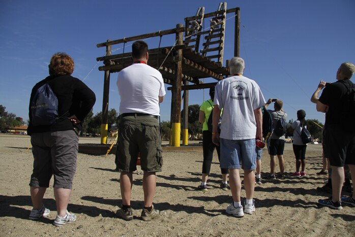 Educators from Recruiting Stations Kansas City and Lansing watch as Marines demonstrate how to properly ascend the A-frame during the 2014 Educators' Workshop at Marine Corps Recruit Depot San Diego. 