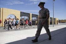 Staff Sgt. Theodoor A. Steber, a drill instructor, marches educators during the Educators' Workshop at Marine Corps Recruit Dept San Diego April 8, 2014. The educators were instructed on the proper response to common terms during recruit training, such as "eyeballs" and "ears." 