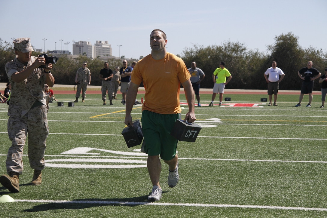 Eric C. McDowell, a Lafayette High School football and basketball coach, carries ammo cans during a portion of the Combat Fitness Test during the Educators' Workshop at Marine Corps Recruit Depot San Diego April 8, 2014.
