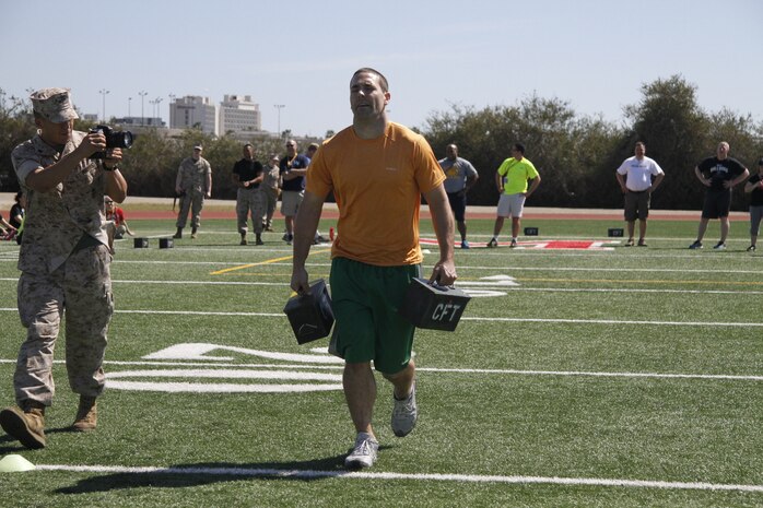 Eric C. McDowell, a Lafayette High School football and basketball coach, carries ammo cans during a portion of the Combat Fitness Test during the Educators' Workshop at Marine Corps Recruit Depot San Diego April 8, 2014.