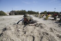 Eric C. McDowell, a Lafayette High School football and basketball coach, low crawls through a portion of the Obstacle Course during the Educators' Workshop at Marine Corps Recruit Depot San Diego April 8, 2014.
