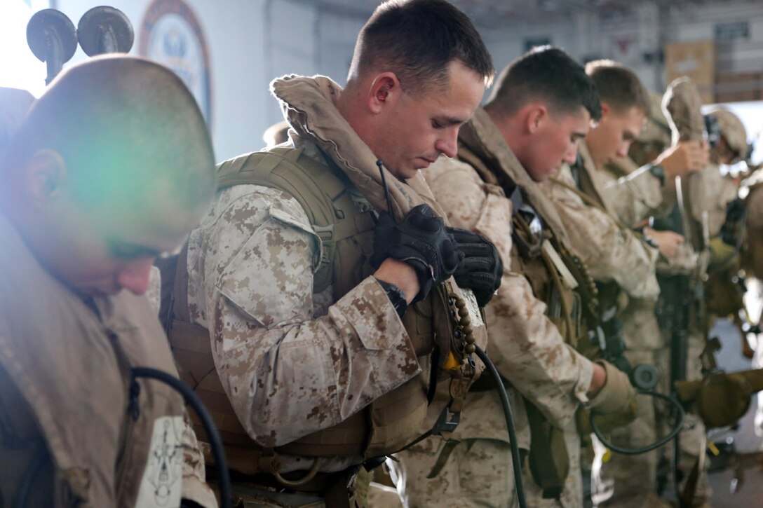 Marines and sailors with Battalion Landing Team 2nd Battalion, 1st Marines, 11th Marine Expeditionary Unit, check flight equipment in the hangar bay of the USS Makin Island prior to loading aircraft and depart for a ship to shore vertical assault training mission during Amphibious Squadron Marine Expeditionary Unit Integration Training (PMINT) off the coast of San Diego, April 15. The 11th MEU and Makin Island Amphibious Ready Group team conducts various amphibious-based operations during PMINT in preparation for their upcoming deployment. (U.S. Marine Corps photo by Gunnery Sgt. Rome M. Lazarus/Released)