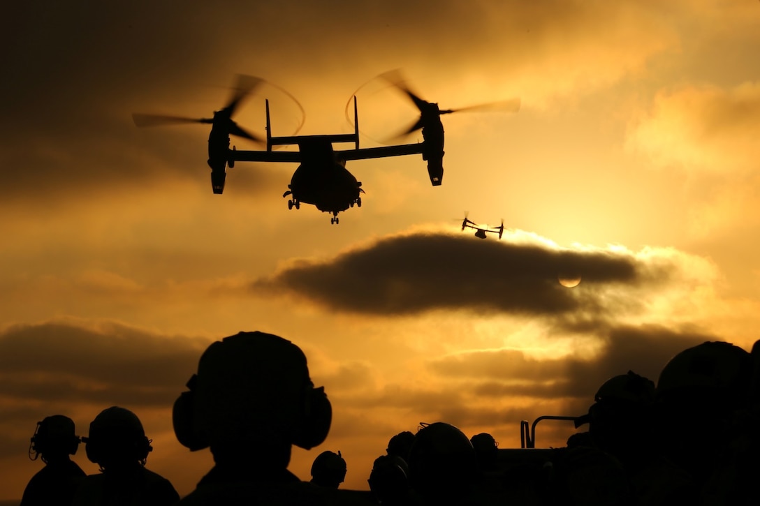 Marines with Marine Medium Tiltrotor Squadron 163 (Reinforced), 11th Marine Expeditionary Unit, watch as MV-22B Ospreys take off from the flight deck of the USS Makin Island during Amphibious Squadron Marine Expeditionary Unit Integration Training (PMINT) off the coast of San Diego, April 15, 2014.  PMINT is a two-week predeployment training event focused on the combined capabilities of the MEU and Amphibious Ready Group (ARG), conducting amphibious operations, crisis response, and limited contingency operations.  (U.S. Marine Corps photo by Lance Cpl. Laura Y Raga/Released)