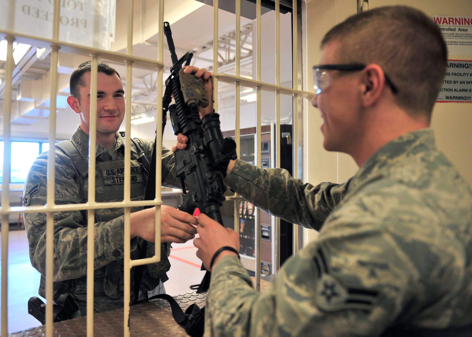 Airman 1st Class Charles Stephens, 354th Security Forces Squadron response force leader, turns in a weapon to the armory after his shift April 17, 2014, Eielson Air Force Base, Alaska. Stephens began working on applying for the Air Force Preparatory School last September and was recently selected to attend. (U.S. Air Force photo by Senior Airman Ashley Nicole Taylor/Released)