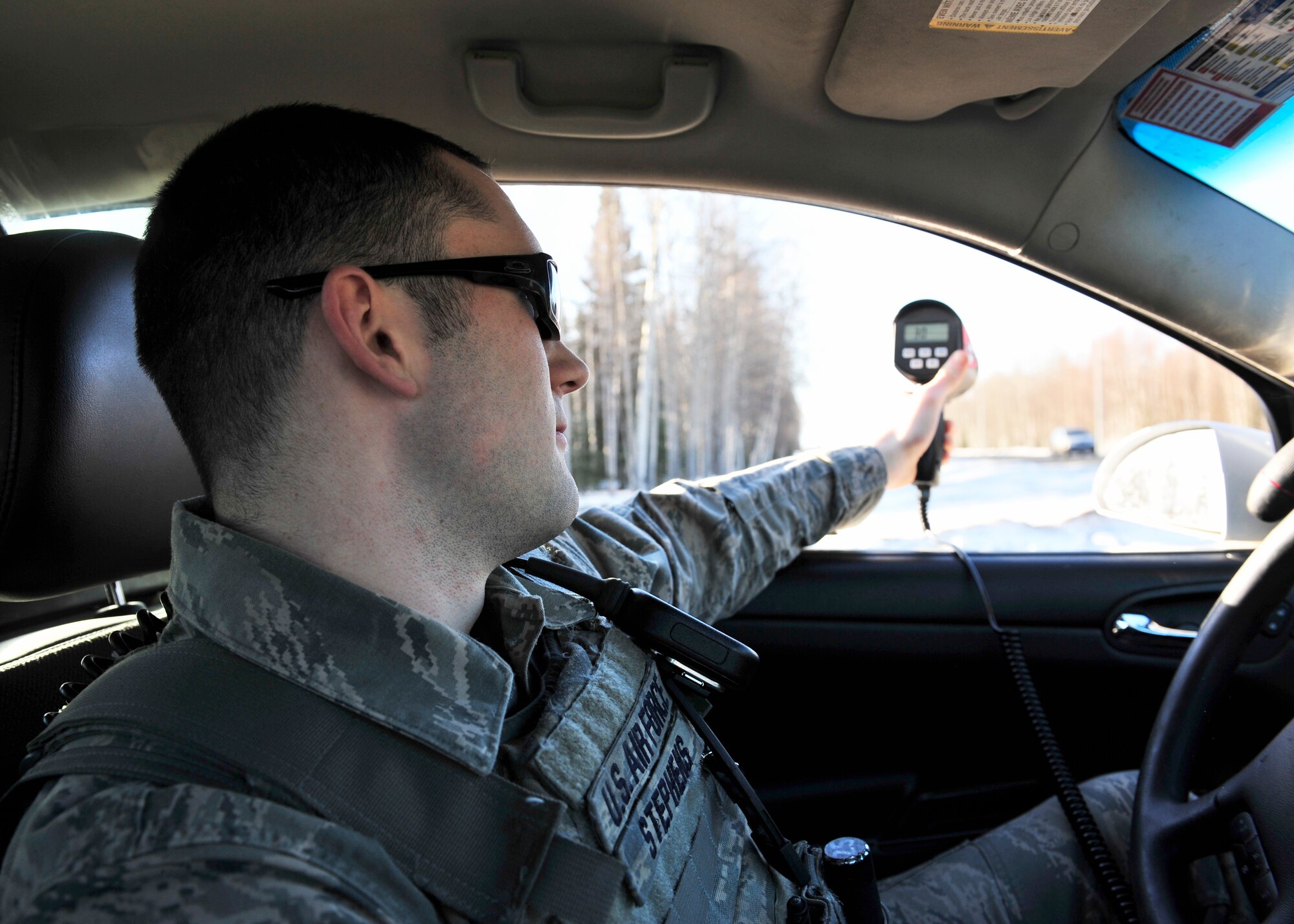 Airman 1st Class Charles Stephens, 354th Security Forces Squadron response force leader, uses a radar to check the speed of passing cars April 17, 2014, Eielson Air Force Base, Alaska. Stephens will attend a 10-month educational program for young Airmen in preparation for attending the Air Force Academy. (U.S. Air Force photo by Senior Airman Ashley Nicole Taylor/Released)