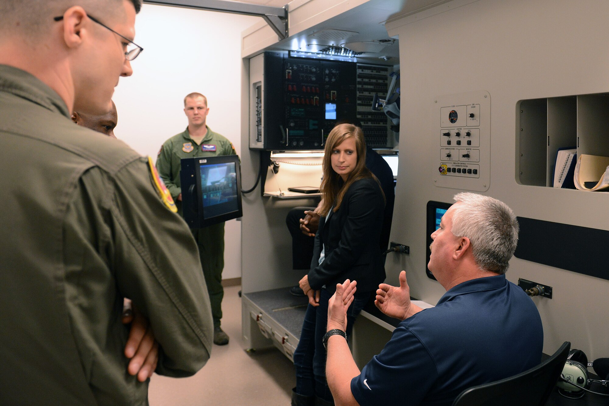 Mark Lewis (right), C-17 Globemaster III aircraft loadmaster simulator instructor, tells congressional staff delegates about a C-17 loadmaster simulator during a base tour April 21, 2014, at Joint Base Lewis-McChord, Wash. During their visit staff delegates were briefed on Team McChord’s various joint partnership missions. (U.S. Air Force photo/Airman 1st Class Jacob Jimenez)   