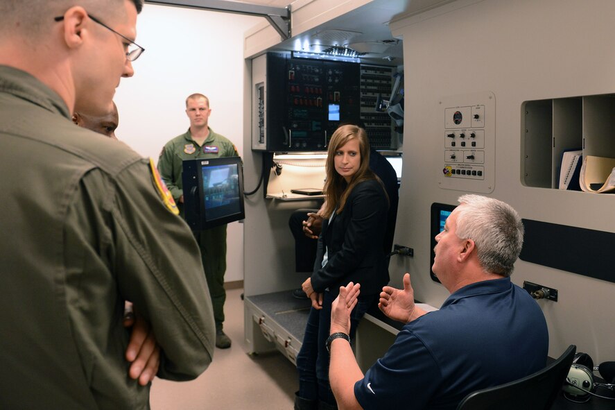 Mark Lewis (right), C-17 Globemaster III aircraft loadmaster simulator instructor, tells congressional staff delegates about a C-17 loadmaster simulator during a base tour April 21, 2014, at Joint Base Lewis-McChord, Wash. During their visit staff delegates were briefed on Team McChord’s various joint partnership missions. (U.S. Air Force photo/Airman 1st Class Jacob Jimenez)   