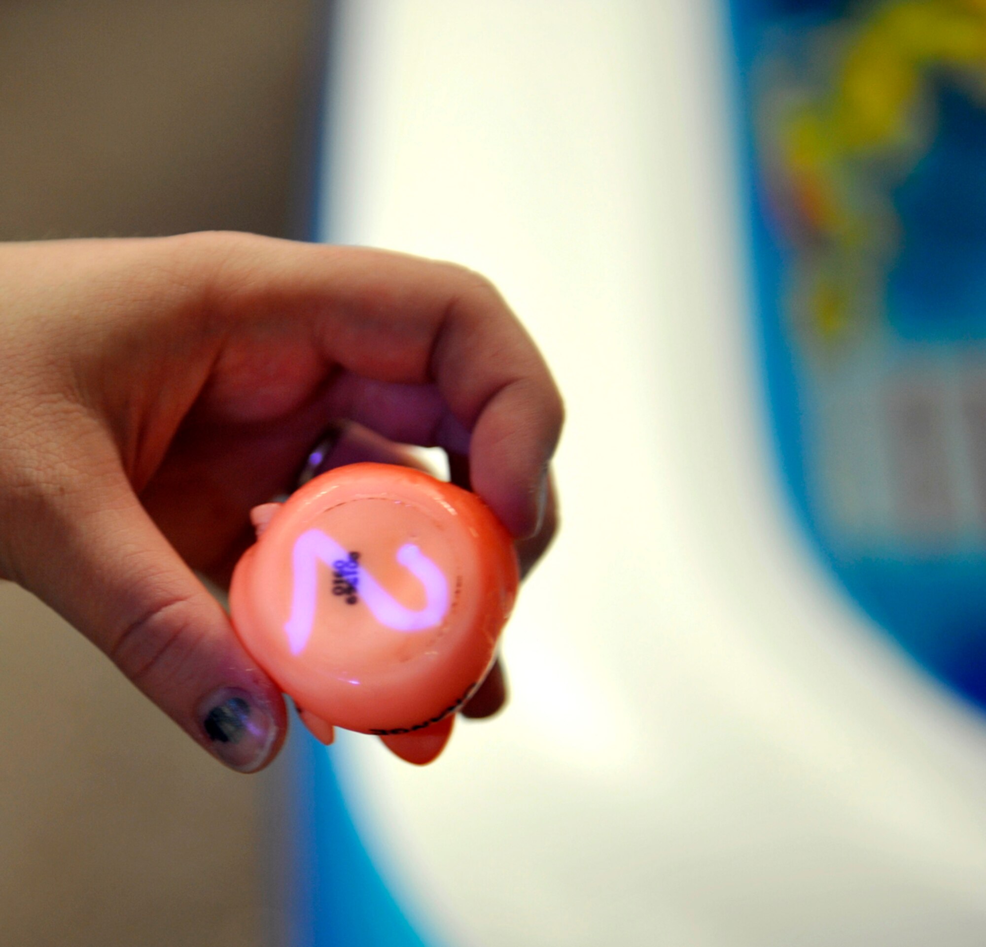 A volunteer illuminates a number on the bottom of a duck during Brunch with the Easter Bunny at the Arctic Oasis on Joint Base Elmendorf-Richardson, Alaska, April 19, 2014. The ducks had a number written underneath them, allowing children to pick a prize. Six hundred military members and families participated in this year’s Brunch with the Easter Bunny. (U.S. Air Force photo/Airman 1st Class Tammie Ramsouer)