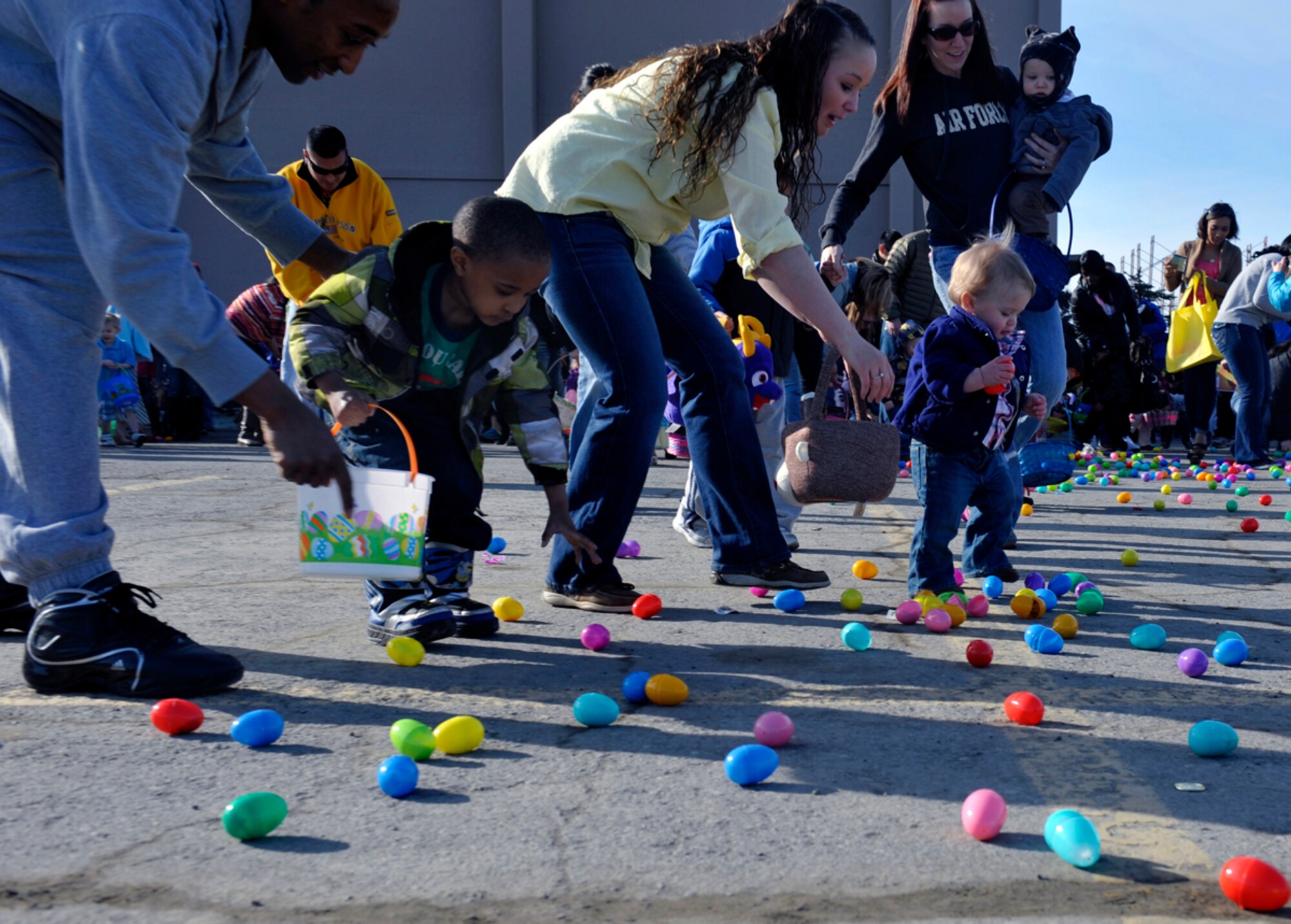 Military members and their families participate in the annual Easter Eggstravaganza at the Buckner Physical Fitness Center on Joint Base Elmendorf-Richardson, Alaska, April 19, 2014. Children up to the age of 12 picked up Easter eggs that contained stickers, candy or plastic toys. For more information about community events, contact the 673d Force Support Squadron Marketing and Publicity office. (U.S. Air Force photo/Airman 1st Class Tammie Ramsouer)
