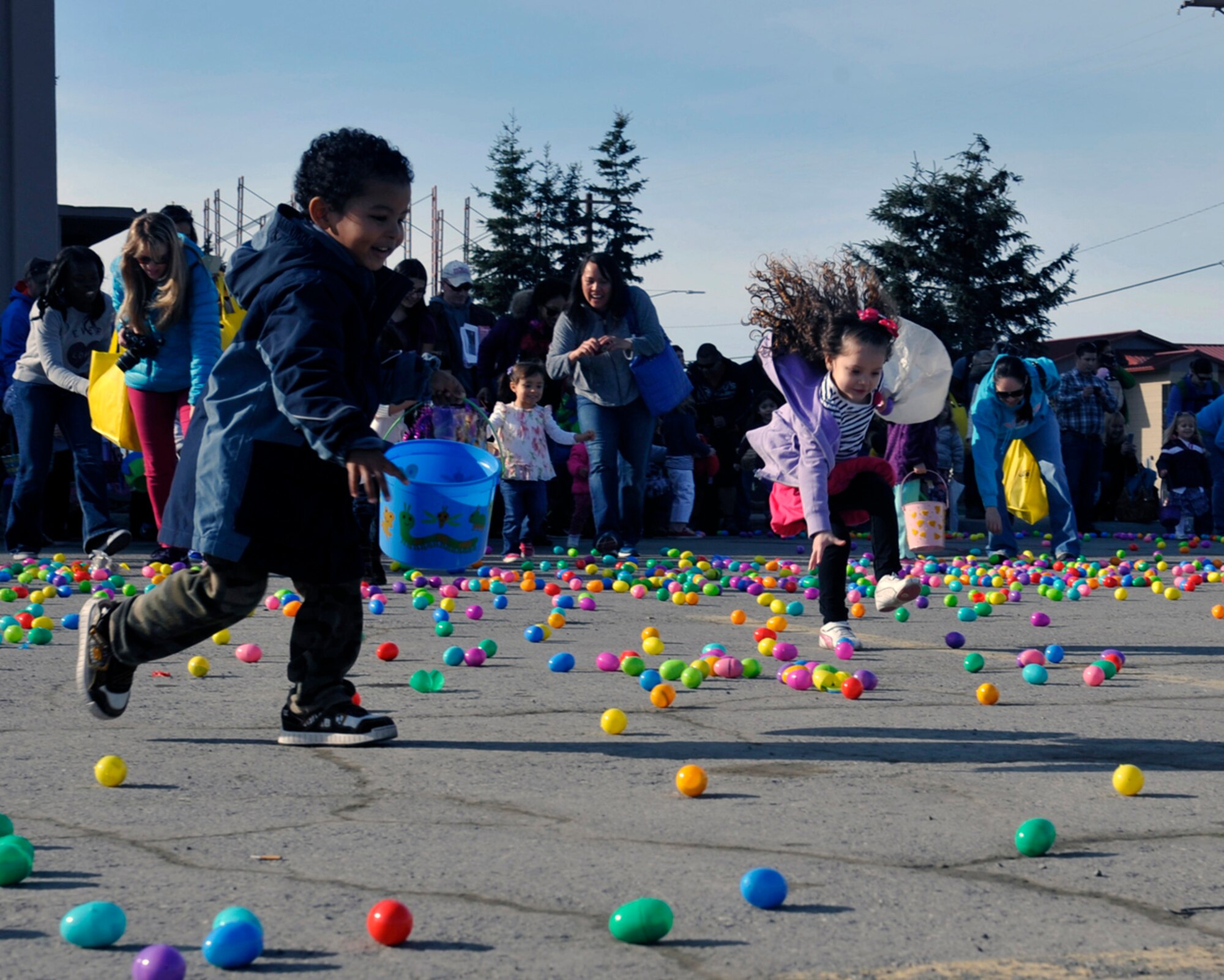Military members and their families participate in the annual Easter Eggstravaganza at the Buckner Physical Fitness Center on Joint Base Elmendorf-Richardson, Alaska, April 19, 2014. The plastic eggs had stickers for children 3-years-old and under, plastic toys for 5 to 8-year-old children and candy for 9 to 12-year-old children. More than 2,000 individuals participated in the seasonal celebration. (U.S. Air Force photo/Airman 1st Class Tammie Ramsouer)