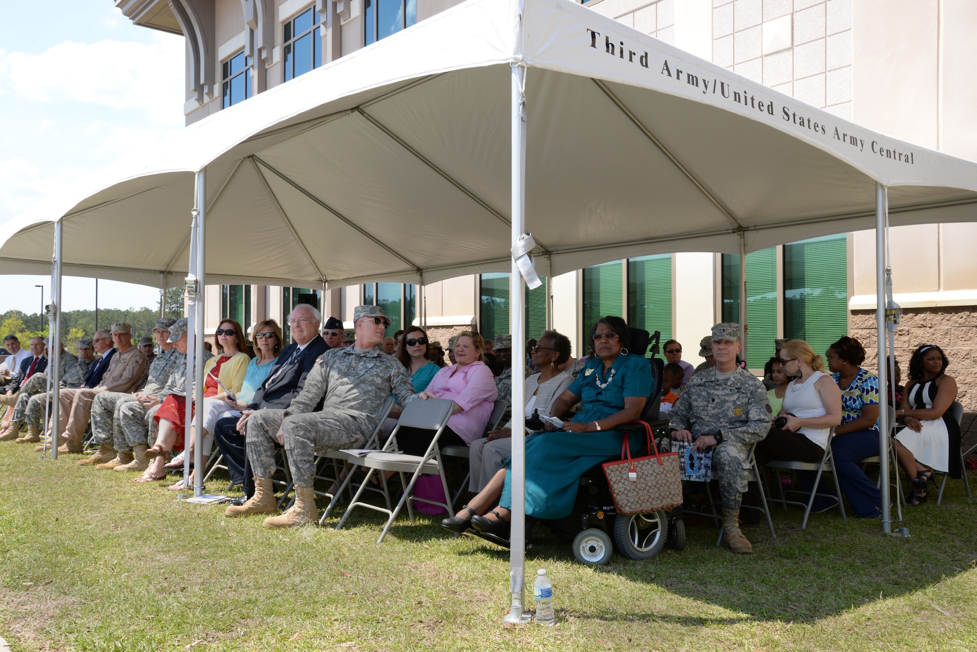 Soldiers, Airmen, city of Sumter officials, and family members gather together outside of the U.S. Army Central headquarters building for an Earth Day recognition event at Shaw Air Force Base, S.C., April 22, 2014. The city of Sumter donated four Palmetto Palm trees, the state tree of South Carolina, to plant outside of the USARCENT headquarters. (U.S. Air Force photo by Airman 1st Class Jonathan Bass/Released)
