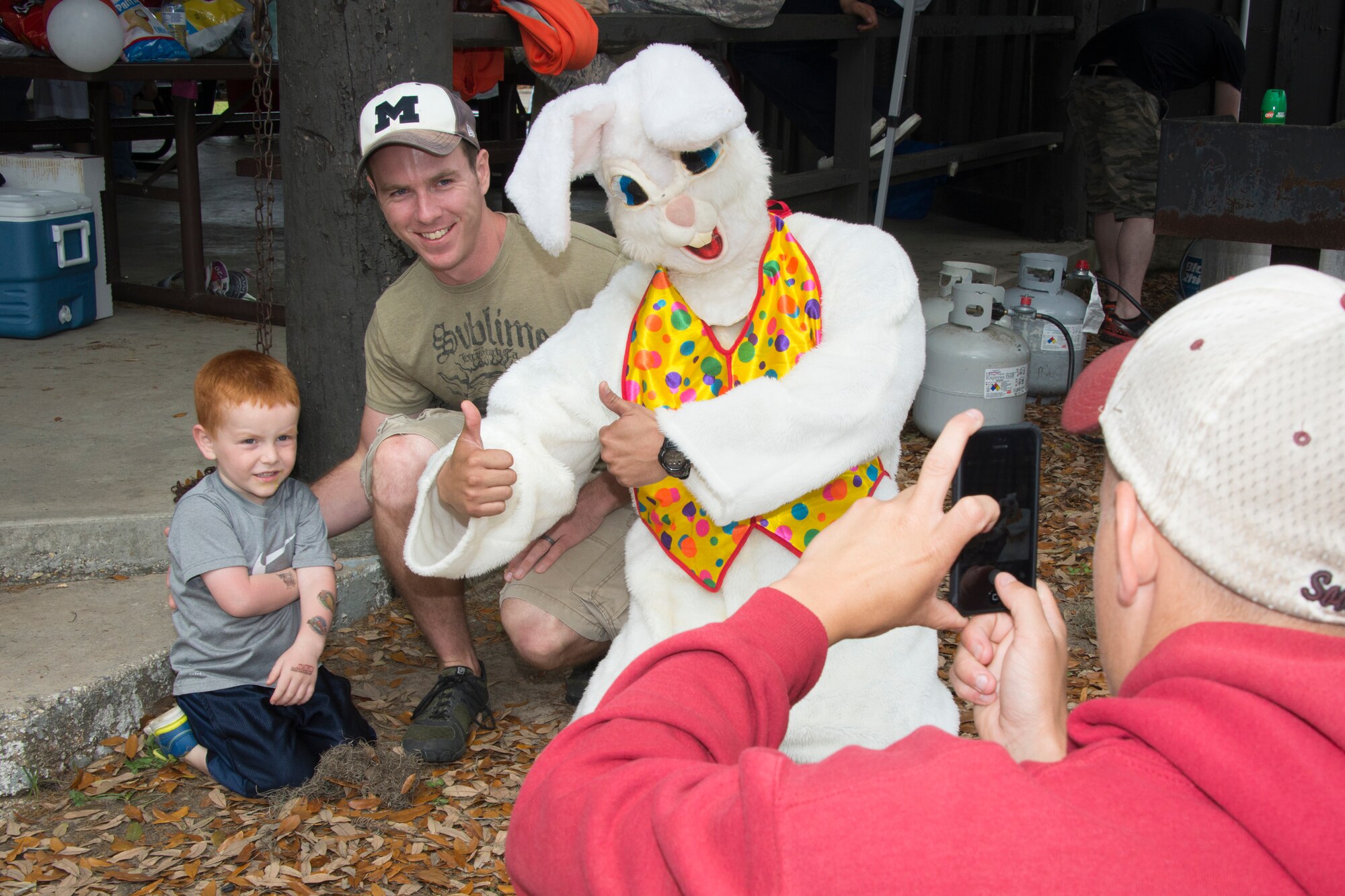 Staff Sgt.  Doug Fraites, 85th Engineering Installation Squadron, and his son take a photo with the Easter Bunny during the squadron’s family day Easter egg hunt April 18, 2014, at the marina, Keesler Air Force Base, Miss.  The event also included a physical training session and a crawfish boil.  (U.S. Air Force photo by Adam Bond)