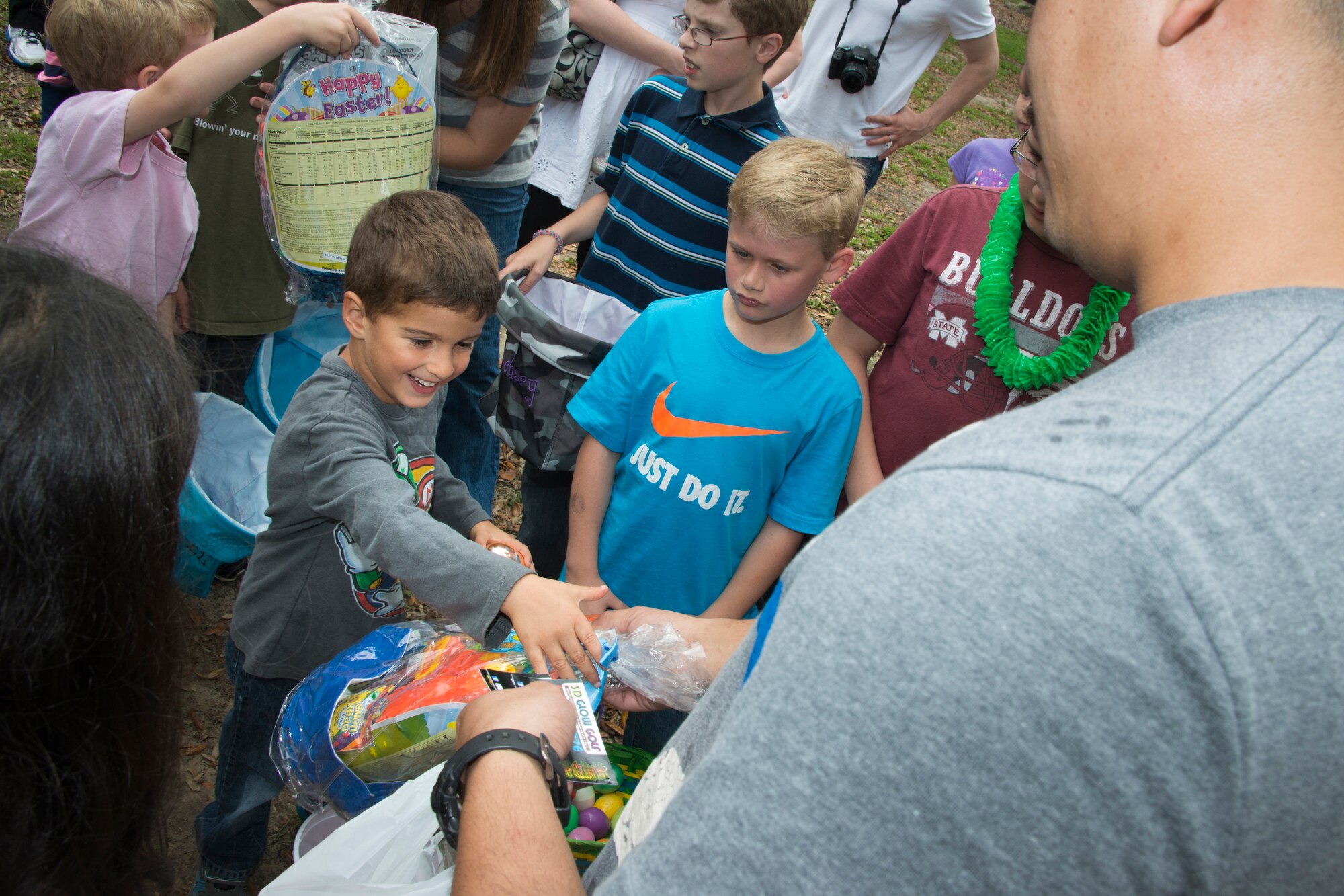 The son of Tech. Sgt. Trandin Watkins, 85th Engineering Installation Squadron, accepts his gift for finding a prize egg during the squadron’s family day Easter egg hunt April 18, 2014, at the marina, Keesler Air Force Base, Miss.  The event also included a physical training session, a crawfish boil and a visit by the Easter Bunny.  (U.S. Air Force photo by Adam Bond)
