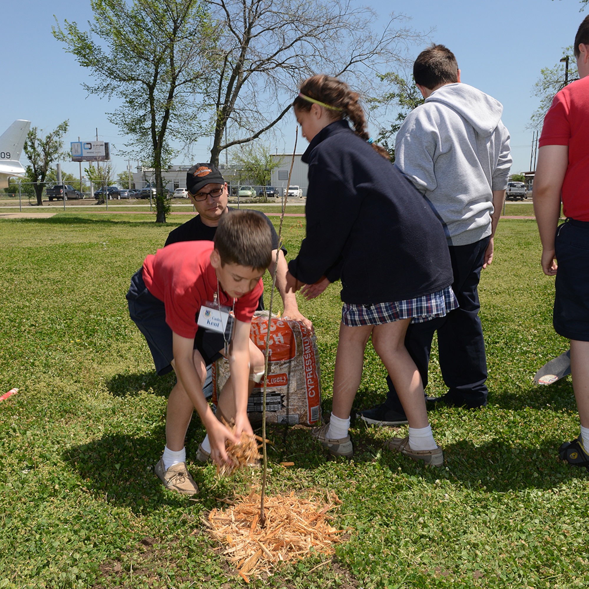 Students from the All Saints Elementary School assist in planting trees at an Earth Day celebration at the 138th Fighter Wing, 22 April 2014.  The 138th FW Environmental Management office organized a cookout and other green activities to celebrate the day at the Tulsa Air National Guard base, Tulsa Okla.  (U.S. National Guard photo by Senior Master Sgt.  Preston L. Chasteen/Released)