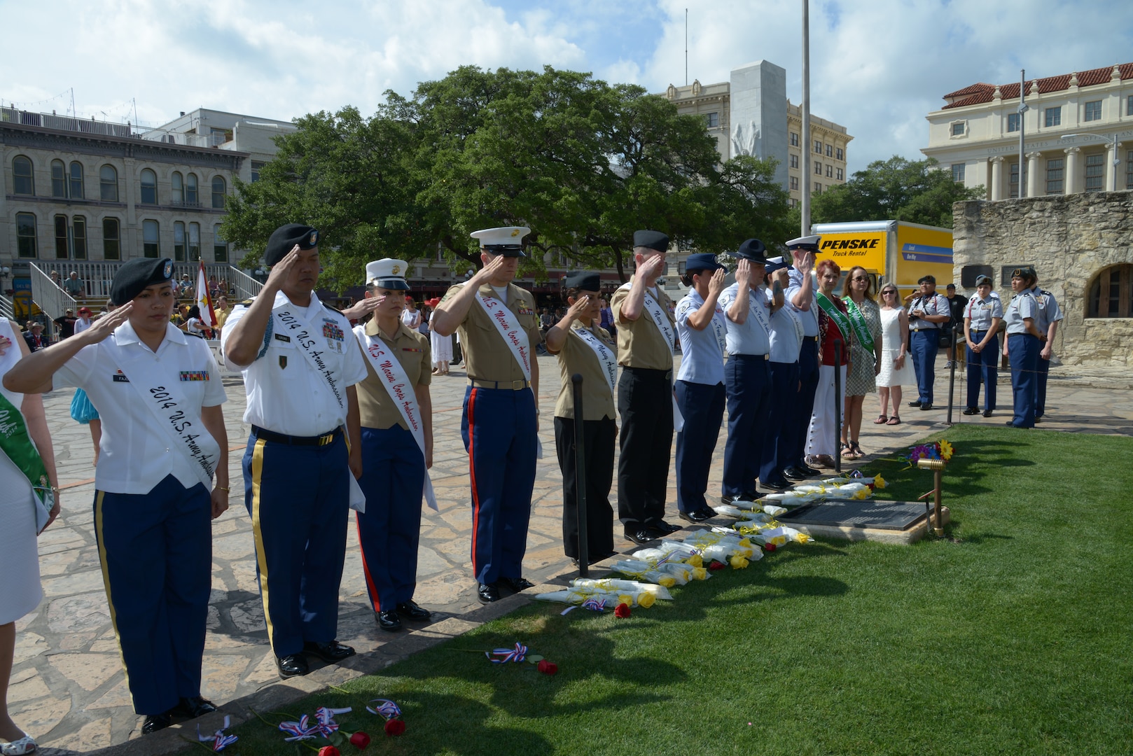 The 2014 military ambassadors, representing all branches of the Joint Base San Antonio military services, salute at the Alamo during the Pilgrimage to the Alamo event as April 21 in San Antonio. The annual pilgrimage began in 1925 at the initiation of the Alamo Mission Chapter of the Daughters of the Republic of Texas. During the procession and wreath-laying in Alamo Plaza, the names of the Alamo defenders are read, and a memorial service and the playing of Taps concludes the ceremony. (U.S. Air Force photo by Joel Martinez)