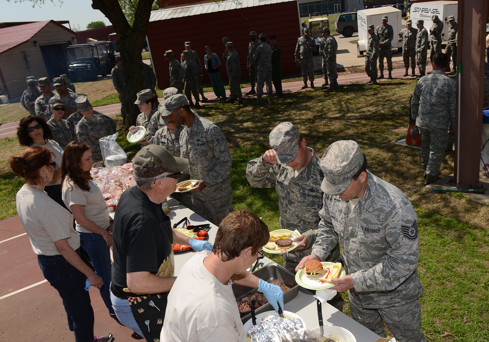 Volunteers serve members of the 138th Fighter Wing during an Earth Day celebration at the 138th FW, 22 April 2014.  The 138th FW Environmental Management office organized a cookout and other green activities to celebrate the day at the Tulsa Air National Guard base, Tulsa Okla.  (U.S. National Guard photo by Senior Master Sgt.  Preston L. Chasteen/Released)