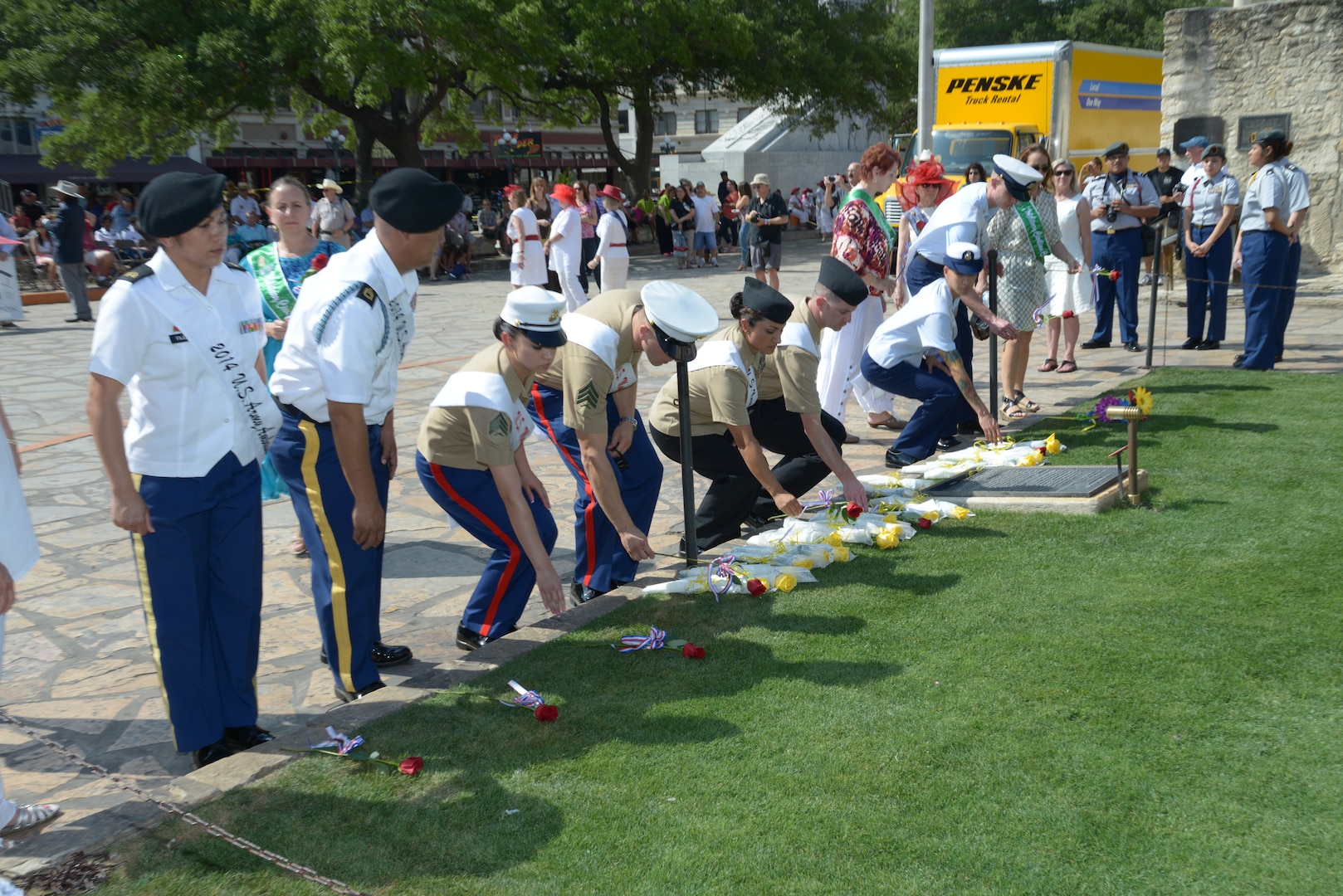 The 2014 military ambassadors, representing all branches of the Joint Base San Antonio military services, place their flowers at the Alamo during the Pilgrimage to the Alamo event as April 21 in San Antonio. The annual pilgrimage began in 1925 at the initiation of the Alamo Mission Chapter of the Daughters of the Republic of Texas. During the procession and wreath-laying in Alamo Plaza, the names of the Alamo defenders are read, and a memorial service and the playing of Taps concludes the ceremony. (U.S. Air Force photo by Joel Martinez)