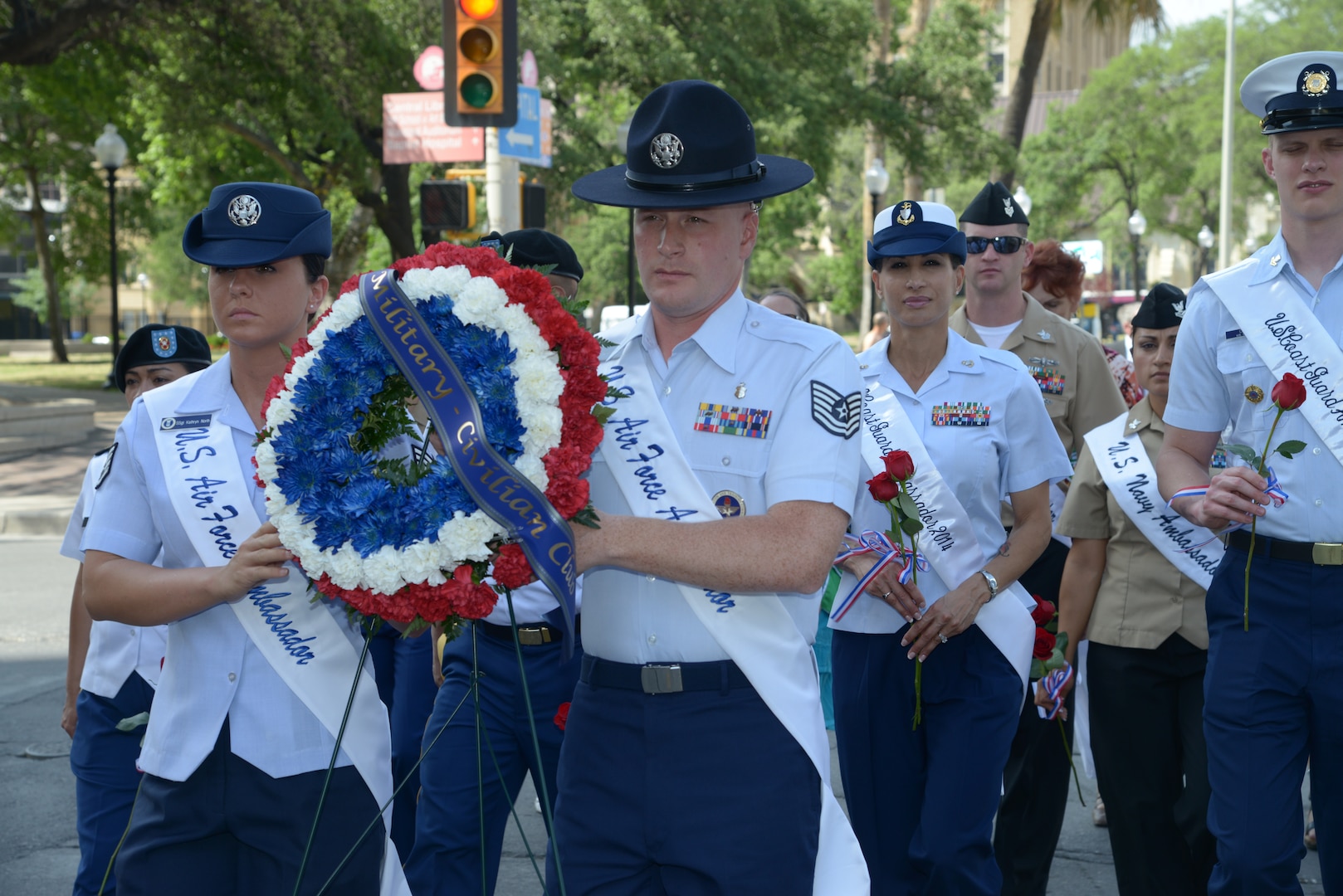 The 2014 military ambassadors carry a wreath and follow the processional April 21 during the annual San Antonio Fiesta Pilgrimage to the Alamo, a memorial tribute to the Alamo heroes and the heritage of Texas. The wreath-bearing procession is a solemn occasion during which historic, civic, patriotic, military and school groups depart Municipal Auditorium and walk silently to the Alamo. (U.S. Air Force photo by Joel Martinez)