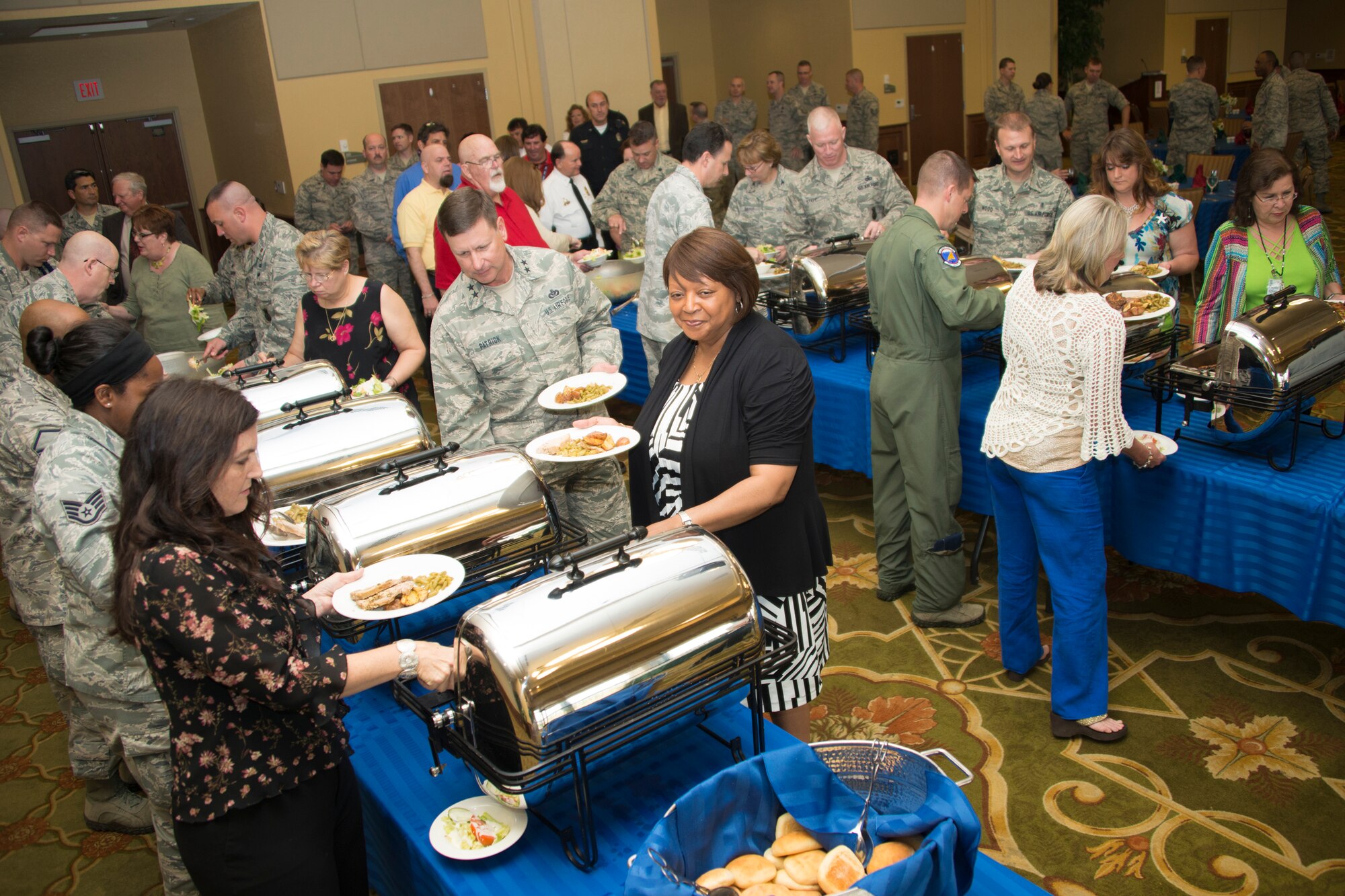 Keesler personnel make their way through the buffet line during the Mississippi Special Olympics kickoff luncheon April 17, 2014, at the Bay Breeze Event Center, Keesler Air Force Base, Miss.  The purpose of the event was to encourage Keesler personnel and base leadership to volunteer for the games which will be held May 9-11. (U.S. Air Force photo by Adam Bond) 