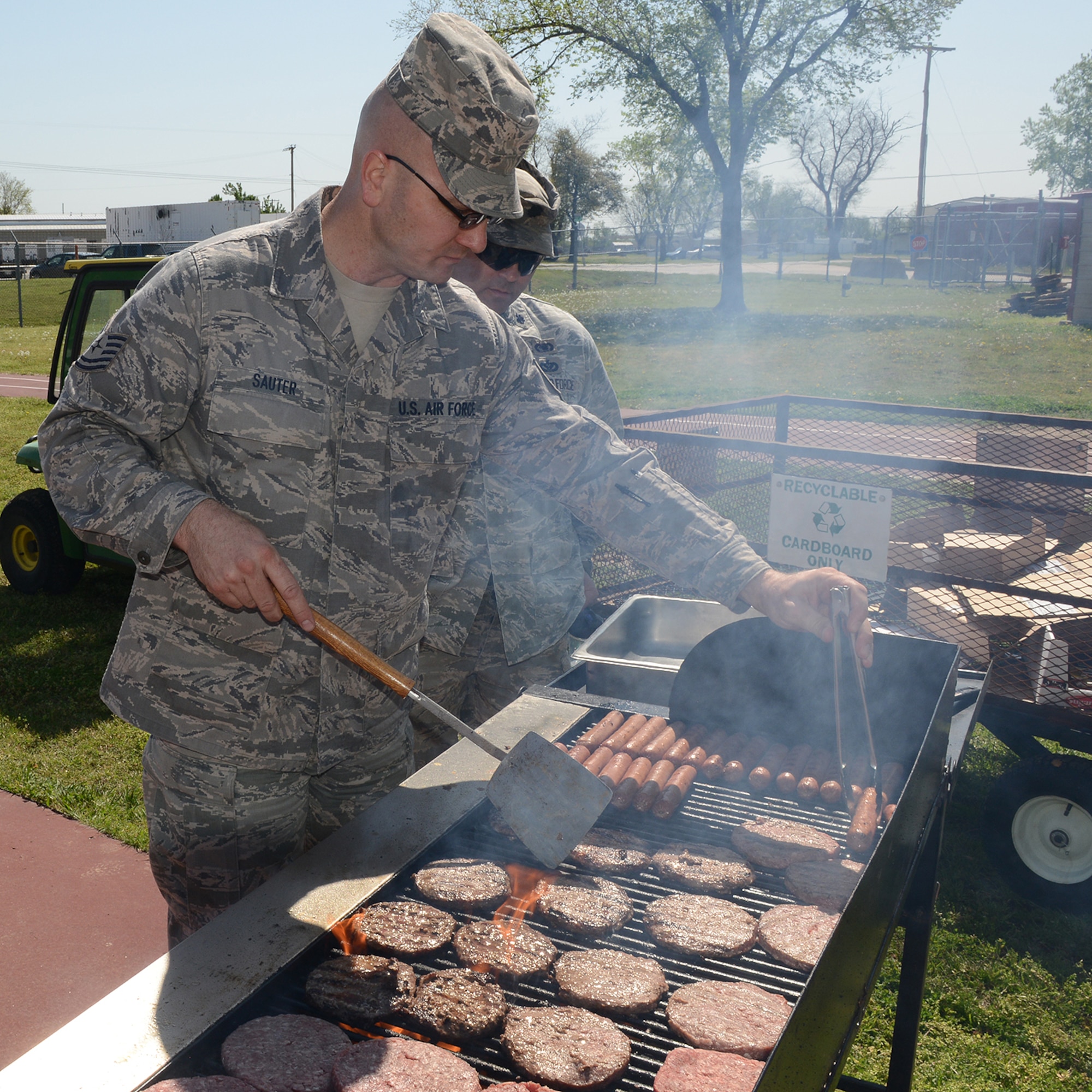 Technical Sergeant Michael Sauter, 138th Communications Flight,  cooks hamburgers in preparation for Earth Day celebration at the 138th Fighter Wing, 22 April 2014.  The 138th FW Environmental Management office organized a cookout and other green activities to celebrate the day at the Tulsa Air National Guard base, Tulsa Okla.  (U.S. National Guard photo by Senior Master Sgt.  Preston L. Chasteen/Released)