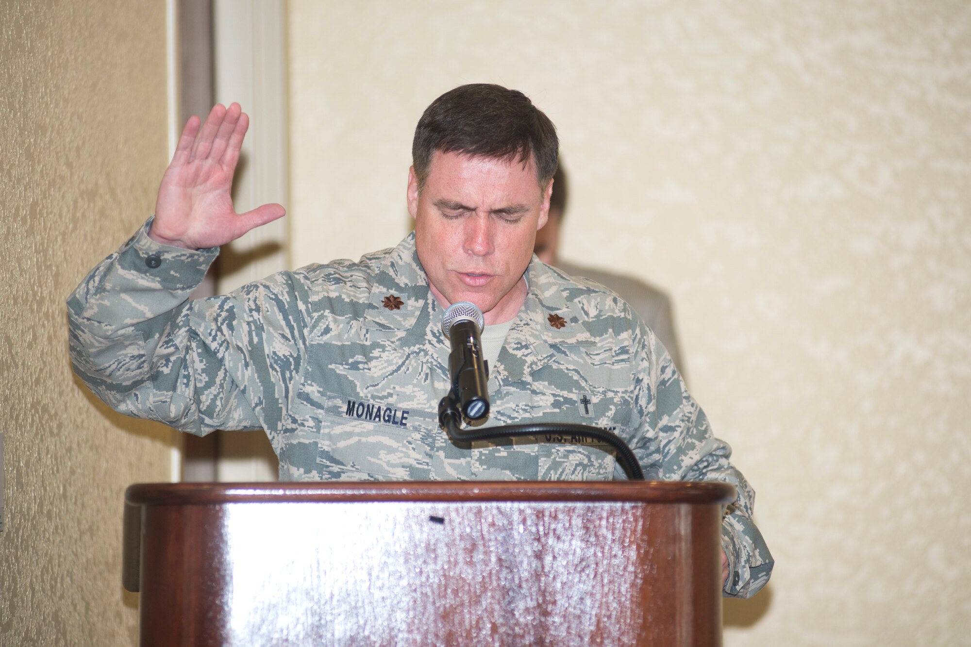 Chaplain (Maj.) Robert Monagle, 81st Training Wing, delivers the invocation during the Mississippi Special Olympics kickoff luncheon April 17, 2014, at the Bay Breeze Event Center, Keesler Air Force Base, Miss.  The purpose of the event was to encourage Keesler personnel and base leadership to volunteer for the games which will be held May 9-11. (U.S. Air Force photo by Adam Bond)