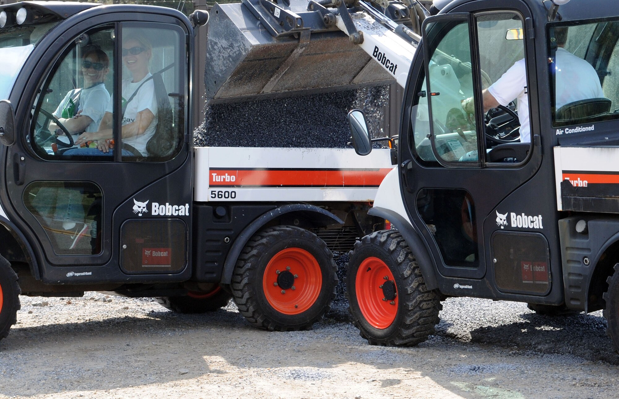 Gravel is placed into the bed of a machine to be delivered to various locations on a trail here as part of Earth Day, April 22, 2014. Earth Day was first celebrated on April 22, 1970. (U.S. Air Force photo/Airman 1st Class Ryan J. Sonnier)
