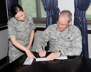 1st Lt. Amy Torres, Joint Base San Antonio Installation Project Officer for the Air Force Assistance Fund, hand delivers the 2014 AFAF donation form April 9 to Brig. Gen. Bob LaBrutta, 502nd Air Base Wing and JBSA commander. The annual Air Force Assistance Fund campaign for JBSA, which has the theme of “Commitment to Caring,” runs through May 2 and raises funds for the charitable affiliates that provide support to the Air Force family (active duty, retirees, reservists, guard and their dependents, including surviving spouses) in need. The four charities are the Air Force Aid Society, Gen. and Mrs. Curtis E. LeMay Foundation, the Air Force Village and the Air Force Enlisted Village. These organizations help Air Force people with aid in an emergency, with educational needs, or to have a secure retirement home for widows or widowers of Air Force members in need of financial assistance. These charities are not a part of the Combined Federal Campaign lineup. The combined goal for JBSA this year is $363,000. Visit http://www.afassistancefund.org for information. (U.S. Air Force photo by Olivia Mendoza)