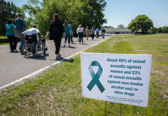 Personnel from the Joint Base Charleston – Weapons Station and Space and Naval Warfare Systems Center Atlantic, take part in a "Walk a Mile in their Shoes" event held on the Weapons Station, April 22, 2014, to raise awareness during Sexual Assault Awareness Month. (U.S. Navy photo/Joe Bullinger)