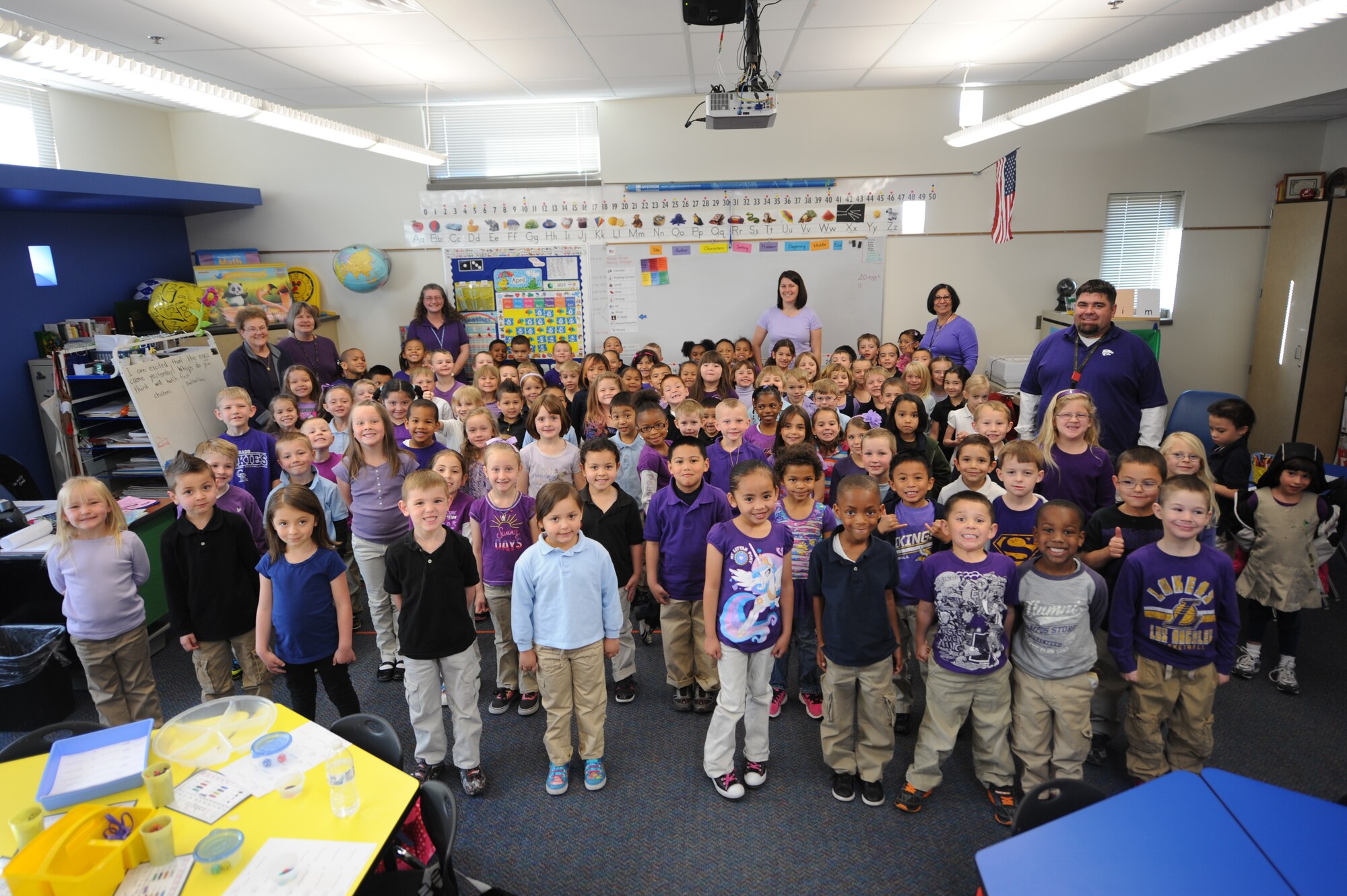 COLORADO SPRINGS, Colo. – Kindergarten students and teachers from McAuliffe Elementary School pose for a picture in their purple shirts April 15 showing support for Month of the Military Child. The color purple represents joint operations or all services connected; the majority of children at McAuliffe Elementary School are military children whose parents belong to all branches of service. Other schools and administrators in District 11 also wore purple in support of Month of the Military Child. (U.S. Air Force photo/Staff Sgt. Jacob Morgan)