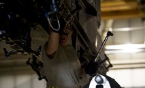 Senior Airman Kasey Castor, 5th Aircraft Maintenance Squadron weapons load crew member, performs a bomb rack preparation on a B-52H Stratofortress during a weapons-loading competition at Minot Air Force Base, N.D., April 17, 2014. As part of Air Force Global Strike Command, load crews work endlessly to preserve our nation’s security by providing combat-ready forces for nuclear deterrence and global strike operations. (U.S. Air Force photo/Senior Airman Brittany Y. Auld)