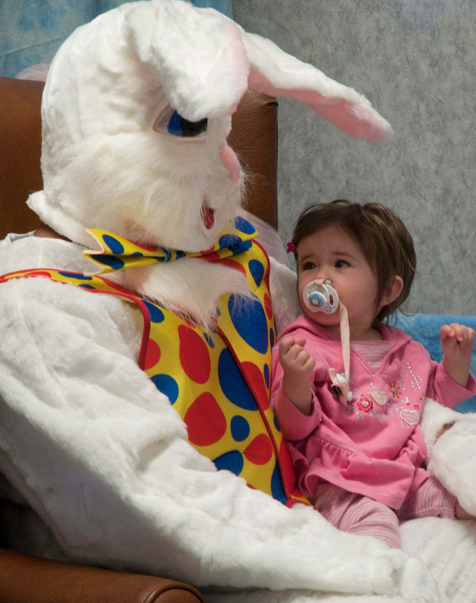 Danielle Schatz, 11 months, daughter of John Schatz, 37th Helicopter Squadron aircrew flight equipment lead mechanic, meets with the Easter Bunny to take a photo during a Breakfast with a Bunny event April 19 at the Trail’s End Club. Several activities were present during the event with breakfast being the main course. Other events included an Easter egg hunt, face painting and a pancake race. A Trash in Show was available for children to participate in to represent Earth Day, where children were supplied with newspapers, egg cartons and other recyclable material to create costumes. (U.S. Air Force photo by Airman Malcolm Mayfield)