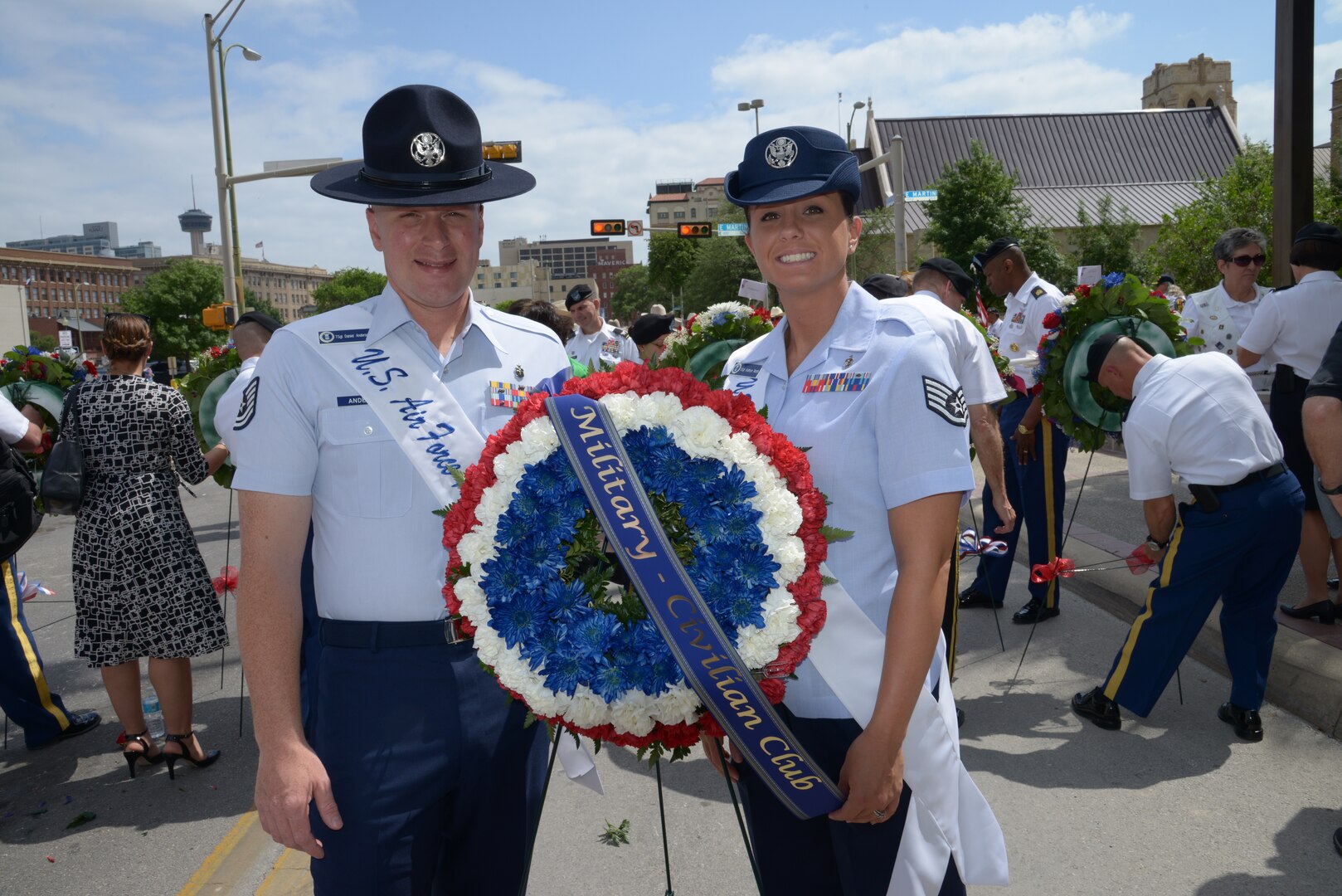 Tech. Sgt. Daniel Anderson, 323rd Training Squadron, left, and Staff Sgt. Kathryn North, 382nd Training Squadron, both 2014 military ambassadors, pose with the Military and Civilian Club wreath before the annual San Antonio Fiesta Pilgrimage to the Alamo event April 21. The event is a memorial tribute to the Alamo heroes and the heritage of Texas. (U.S. Air Force photo by Joel Martinez)