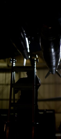 Weapons load crew members load Joint Direct Attack Missile trainers on a B-52H Stratofortress at Minot Air Force Base, N.D., April 17, 2014 during a weapons-loading competition. Each load crew consists of four Airmen who are evaluated every month on how well they load various types of weapons. (U.S. Air Force photo/Senior Airman Brittany Y. Auld)