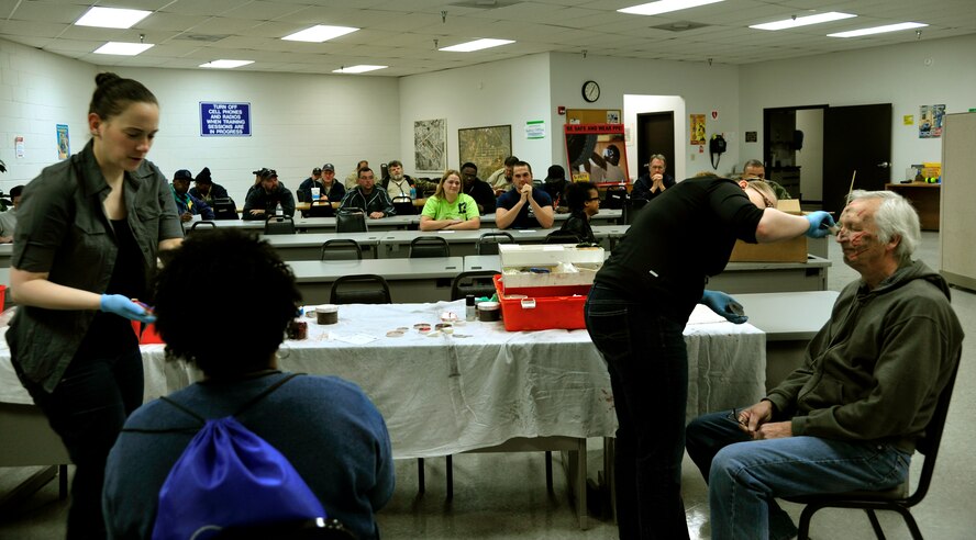 Staff Sgt. Lacey Erbe, Miranda Krill and civilian Clyde Nobles, 375th Medical Group, provided moulaged 21 simulated casualties during a live exercise at Lambert-St Louis International Airport April 19, 2014.  (U.S. Air Force photo/ Staff Sgt. Stephenie Wade)