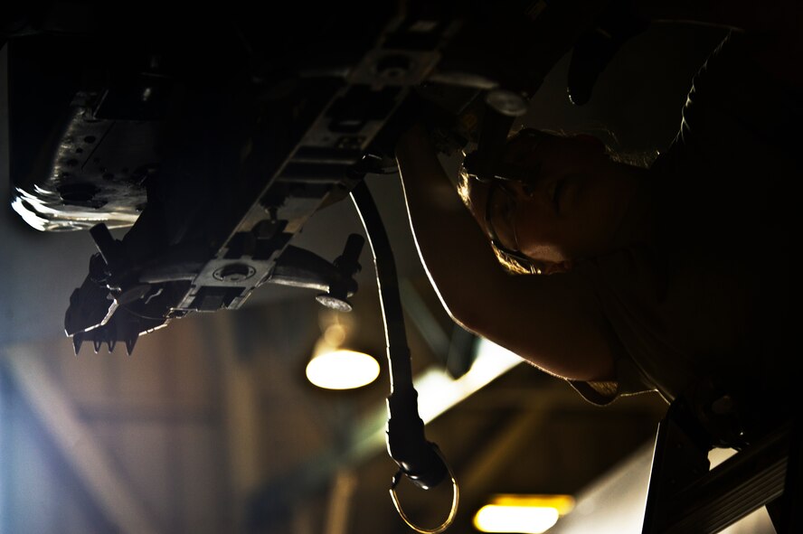Senior Airman Kasey Castor, 5th Aircraft Maintenance Squadron weapons load crew member, prepares to load a Joint Direct Attack Missile trainer on a B-52H Stratofortress at Minot Air Force Base, N.D., April 17, 2014. As part of Air Force Global Strike Command, load crews work endlessly to preserve our nation’s security by providing combat-ready forces for nuclear deterrence and global strike operations. (U.S. Air Force photo/Senior Airman Brittany Y. Auld)