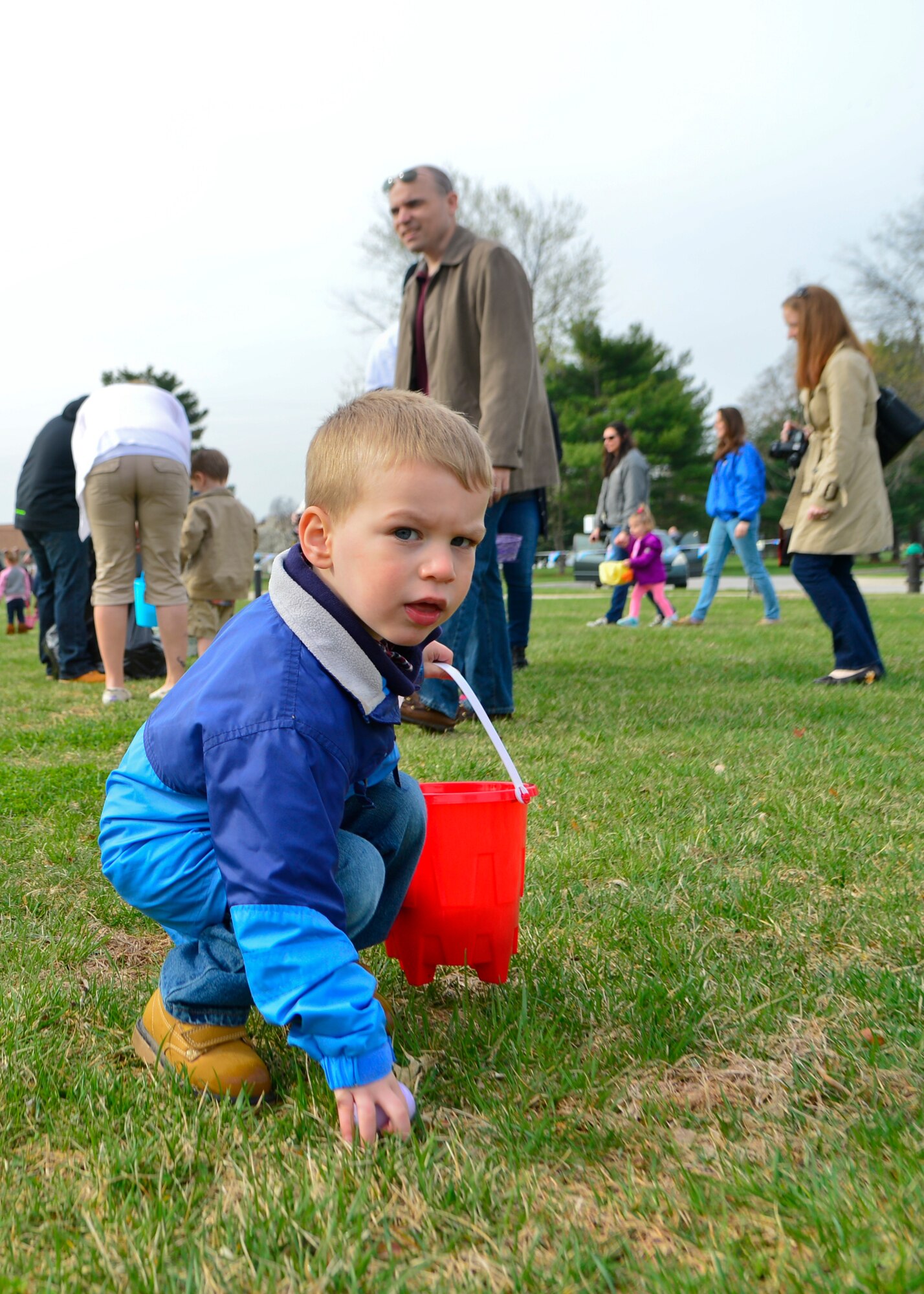 Liam Windsor, son of Tech. Sgt. Keith Windsor, 512th Maintenance Squadron jet engine specialist, picks up an egg during an Easter egg hunt April 19, 2014, at the Youth Center on Dover Air Force Base, Del. The Easter egg hunt had more than 5,000 eggs that were collected by four different age groupsofmilitary children. (U.S. Air Force photo/Airman 1st Class William Johnson)