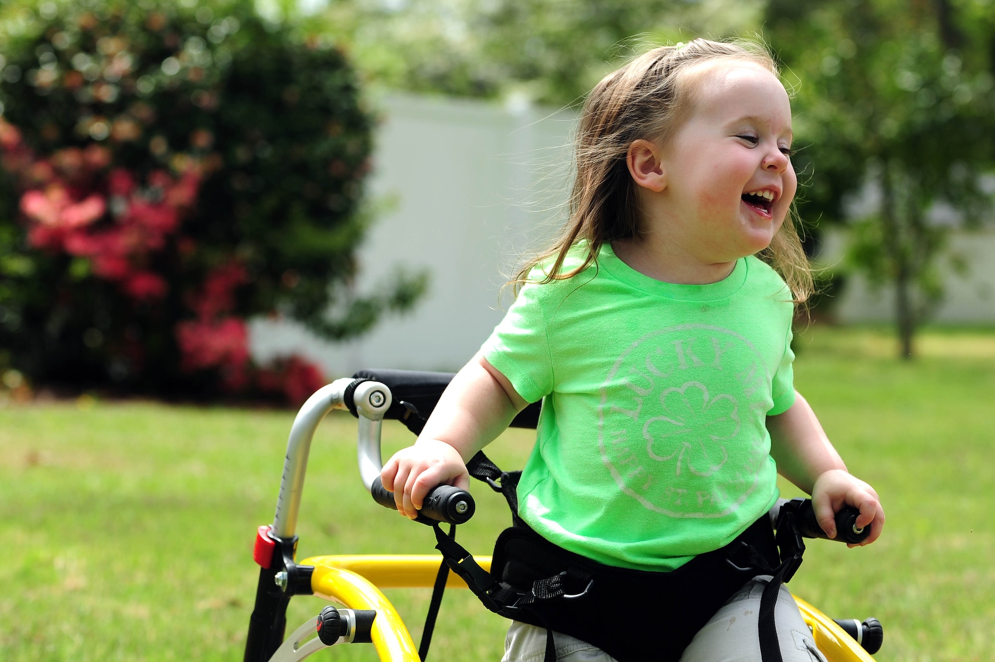 The daughter of retired Air Force Master Sgt. Brian Buss, plays in the front yard of their home, April 18, 2014, in Goldsboro, N.C. Brian’s daughter had trouble walking and standing on her own, until she received medical equipment courtesy of the Air Force Aid Society. To donate, contact a unit Air Force Assistance Fund representative or visit www.afassistancefund.org for more information. (U.S. Air Force photo/Senior Airman John Nieves Camacho)