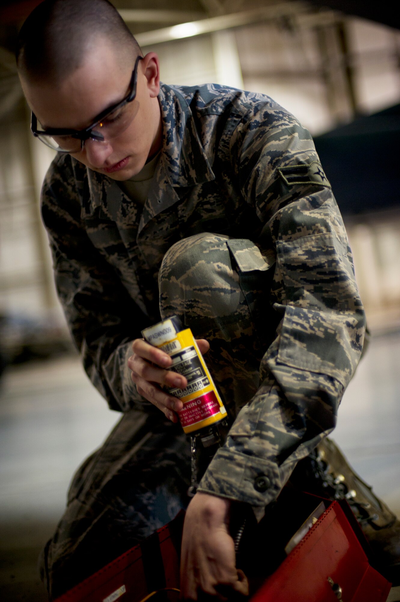 Airman 1st Class Dustin Lumpkin, 5th Aircraft Maintenance Squadron weapons load crew member, prepares to load a Joint Direct Attack Missile trainer on a B-52H Stratofortress during a weapons-loading competition at Minot Air Force Base, N.D., April 17, 2014. Each load crew consists of four Airmen who are evaluated every month on how well they load various types of weapons.  (U.S. Air Force photo/Senior Airman Brittany Y. Auld)