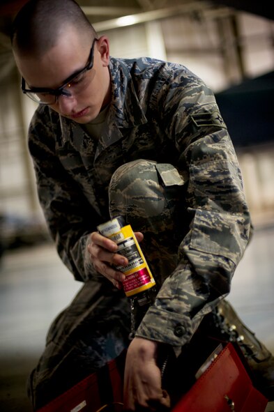 Airman 1st Class Dustin Lumpkin, 5th Aircraft Maintenance Squadron weapons load crew member, prepares to load a Joint Direct Attack Missile trainer on a B-52H Stratofortress during a weapons-loading competition at Minot Air Force Base, N.D., April 17, 2014. Each load crew consists of four Airmen who are evaluated every month on how well they load various types of weapons.  (U.S. Air Force photo/Senior Airman Brittany Y. Auld)